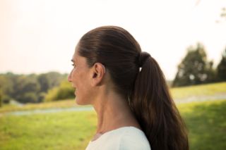 Woman profile with hearing aid