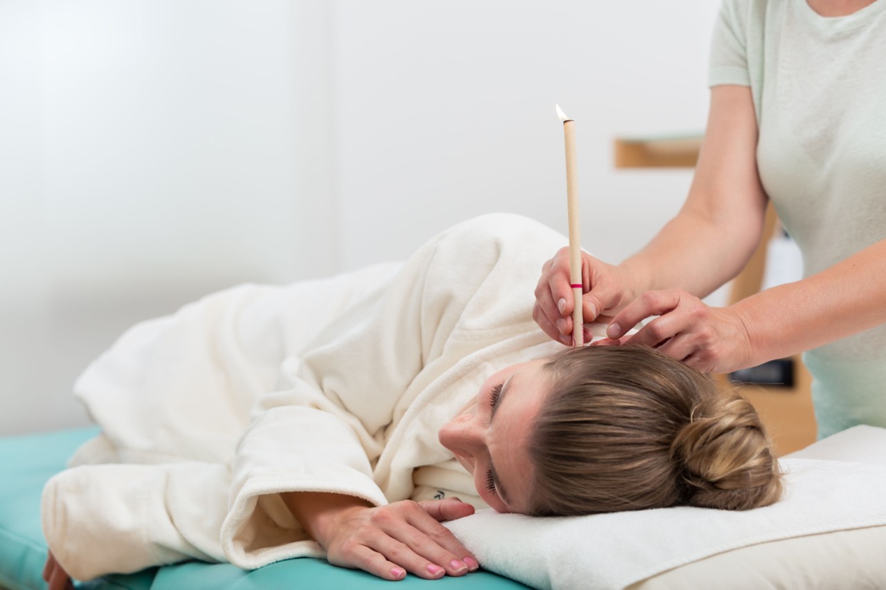 Woman getting ear candle